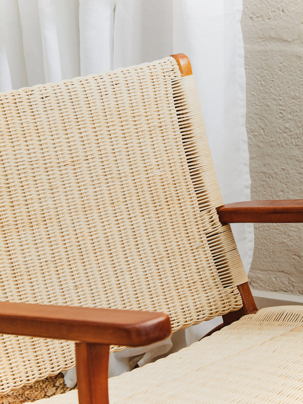 Juno Natural Rattan Armchair lifestyle image in Scandinavian-inspired interior