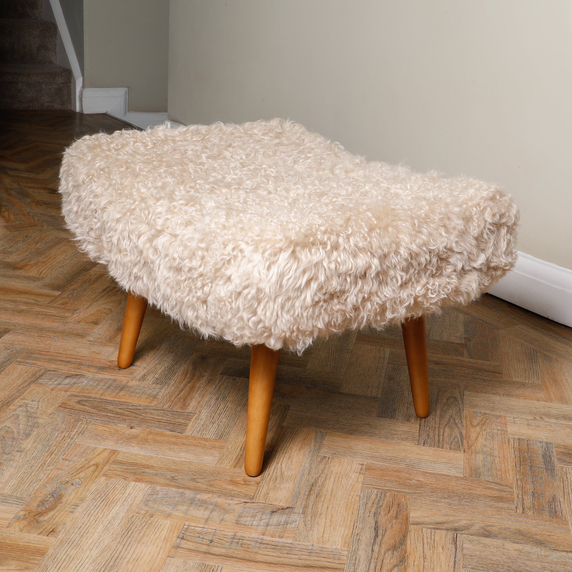 Beige Sheepskin Footstool plush shearling texture detail close-up